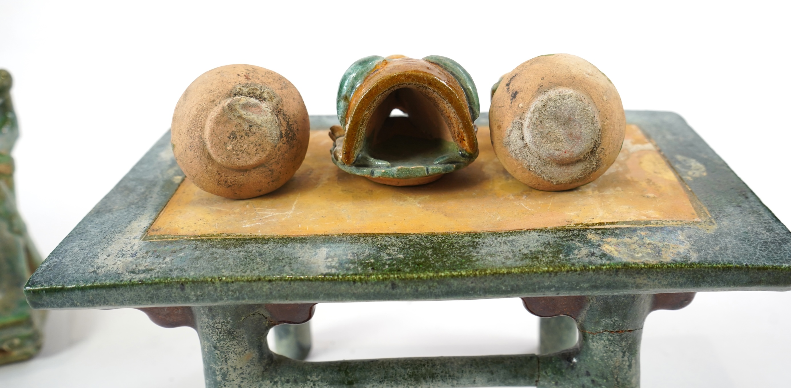 A set of Chinese Ming Sancai models of table with offerings and a pair of horseshoe shaped armchairs, 16th century